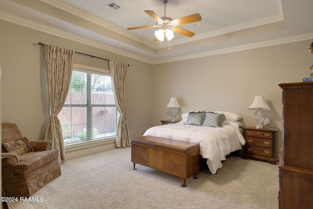 bedroom with light carpet, ornamental molding, a raised ceiling, and visible vents