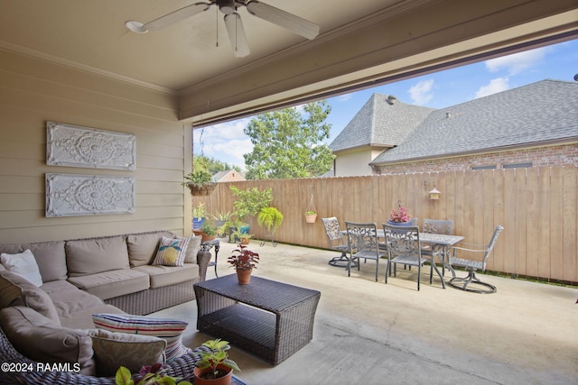 view of patio with outdoor dining area, a fenced backyard, ceiling fan, and an outdoor hangout area