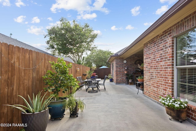 view of patio / terrace featuring fence and outdoor dining area