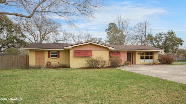 ranch-style home featuring concrete driveway, a front lawn, fence, and brick siding