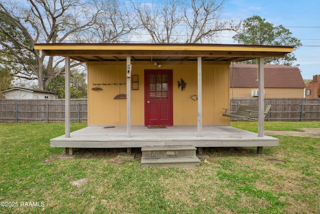 view of outdoor structure featuring fence and an outbuilding