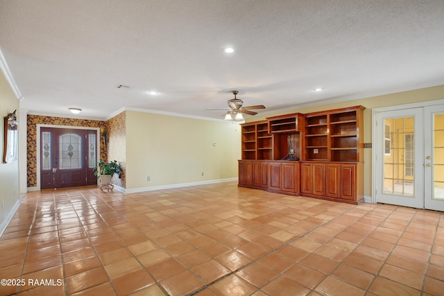 unfurnished living room with a textured ceiling, french doors, and crown molding