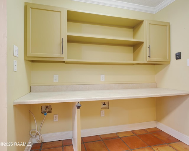 clothes washing area featuring tile patterned flooring, crown molding, and baseboards