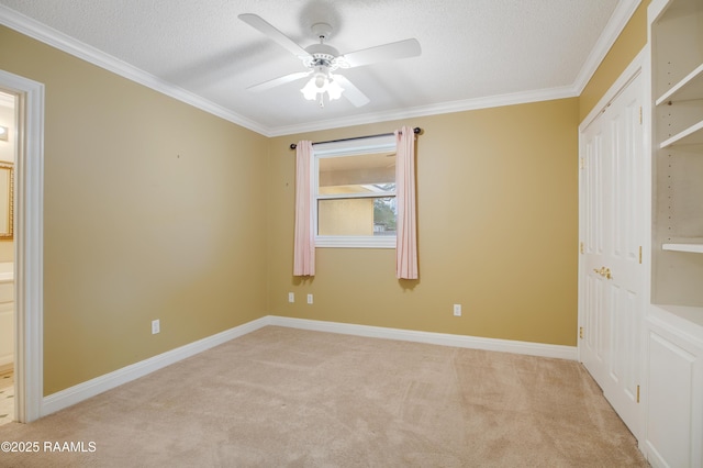 unfurnished bedroom with baseboards, carpet, crown molding, a textured ceiling, and a closet