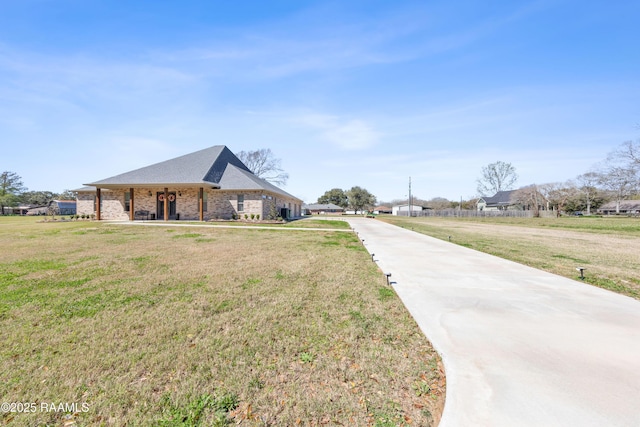 view of front of home featuring a front lawn and brick siding