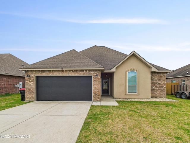 single story home featuring an attached garage, brick siding, a shingled roof, concrete driveway, and a front lawn