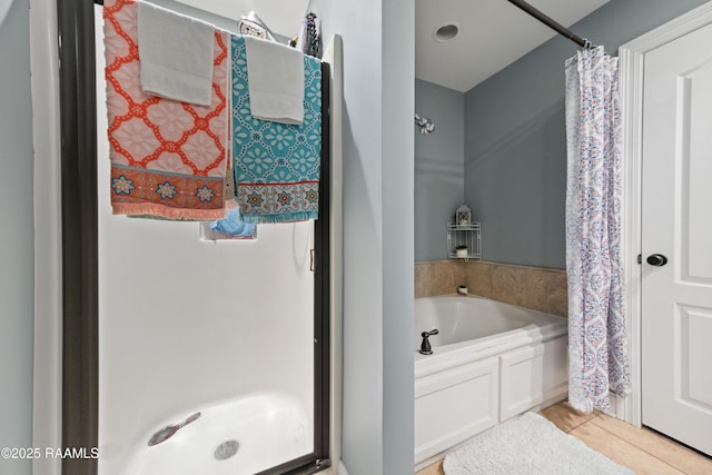 full bathroom with tile patterned flooring, a stall shower, and a bath