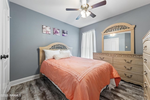 bedroom featuring dark wood-style floors, a ceiling fan, and baseboards