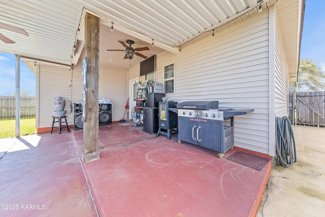 view of patio featuring a ceiling fan and fence