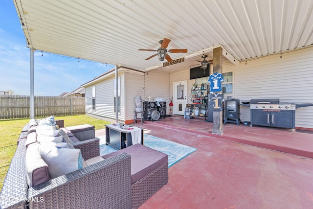 view of patio / terrace with an outdoor living space, area for grilling, fence, and ceiling fan