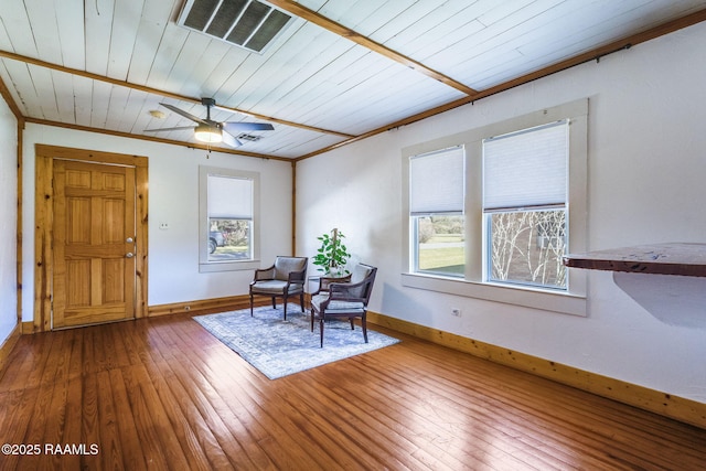 unfurnished room with visible vents, crown molding, baseboards, and hardwood / wood-style floors