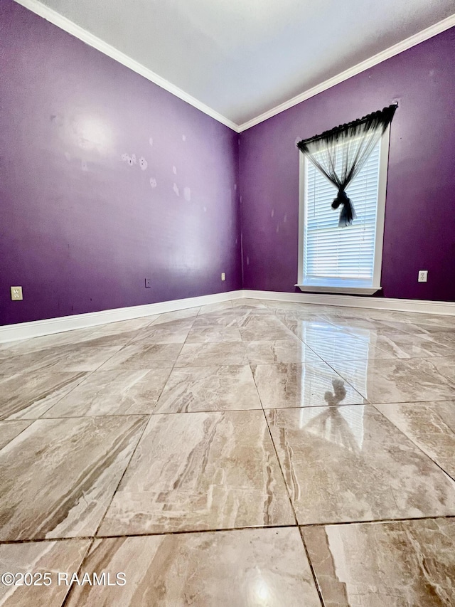 empty room featuring baseboards, marble finish floor, and crown molding