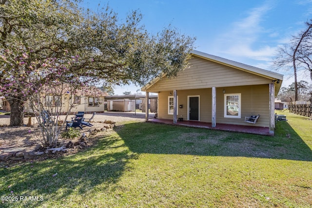 back of house with a patio and a yard