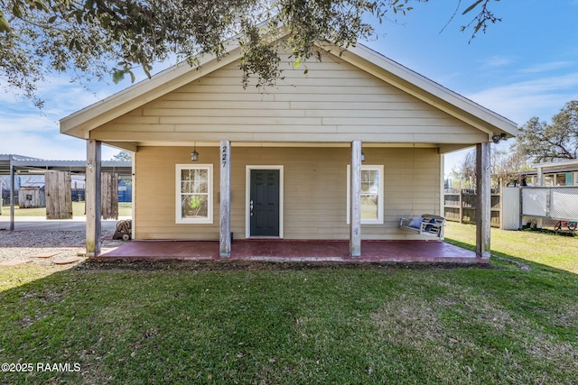 back of house featuring a patio area, fence, and a lawn