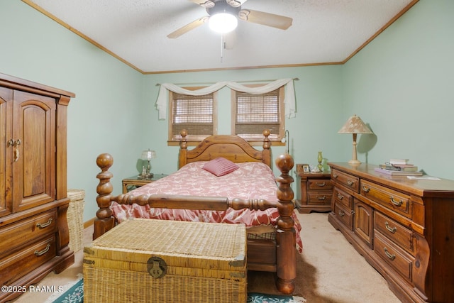 bedroom with a textured ceiling, a ceiling fan, crown molding, and light colored carpet