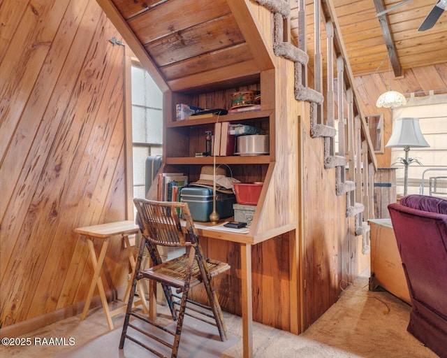 carpeted office featuring vaulted ceiling with beams, plenty of natural light, wooden ceiling, and wooden walls