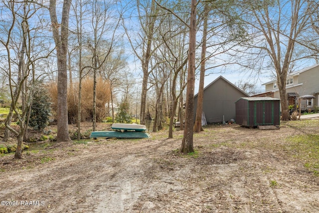 view of yard with a storage shed and an outdoor structure