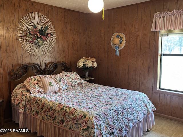 carpeted bedroom featuring wood walls