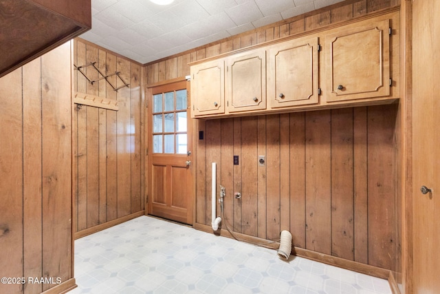 1410 S Chataignier Rd, Ville Platte, LA 70586 - washroom featuring hookup for an electric dryer, cabinet space, gas dryer hookup, and wood walls