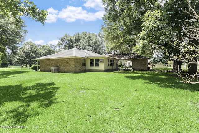 1410 S Chataignier Rd, Ville Platte, LA 70586 - rear view of house with a yard and brick siding