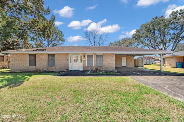 ranch-style home featuring a carport, brick siding, driveway, and a front lawn