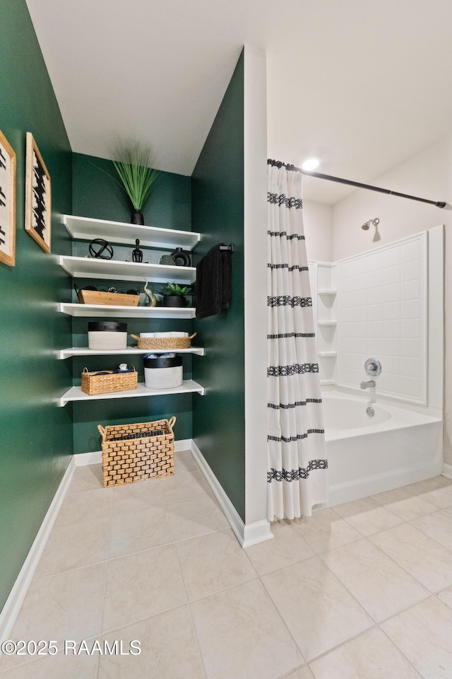 full bathroom featuring tile patterned flooring, baseboards, and shower / bath combo