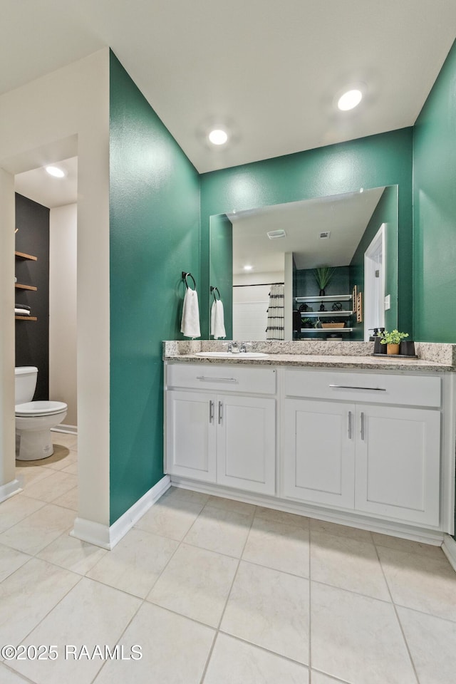 full bathroom featuring baseboards, vanity, toilet, and tile patterned floors