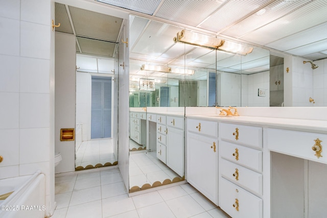 bathroom with a shower, tile patterned flooring, vanity, and toilet