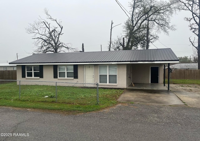 view of front of home with metal roof, brick siding, a fenced front yard, and a front yard