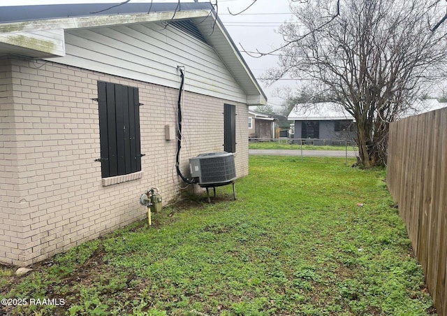 exterior space with a fenced backyard and central AC unit