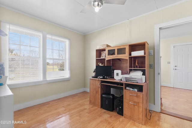 office area featuring baseboards, light wood-style flooring, a ceiling fan, and ornamental molding