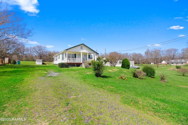 view of side of home with a yard and a porch