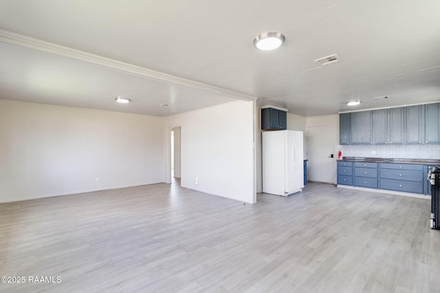 interior space with light wood finished floors and visible vents