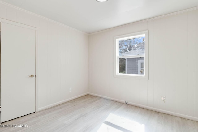 unfurnished bedroom with crown molding, baseboards, and wood finished floors