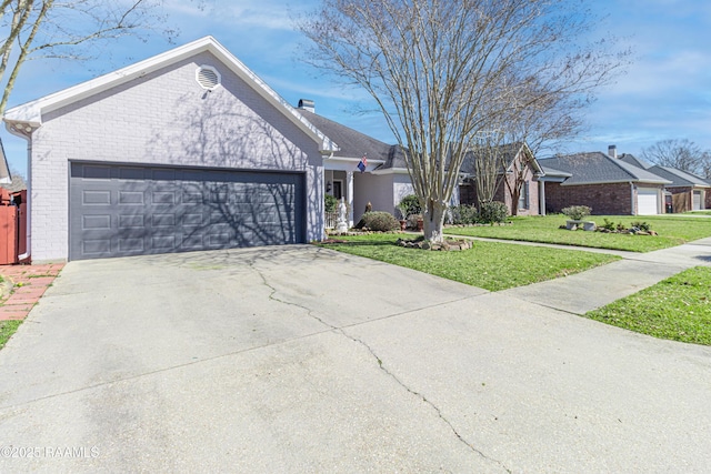 ranch-style house featuring concrete driveway, brick siding, an attached garage, and a front lawn