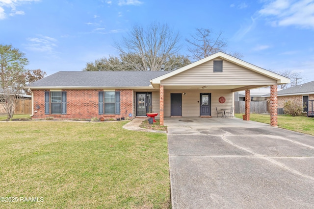 ranch-style home with brick siding, a shingled roof, fence, concrete driveway, and a front yard