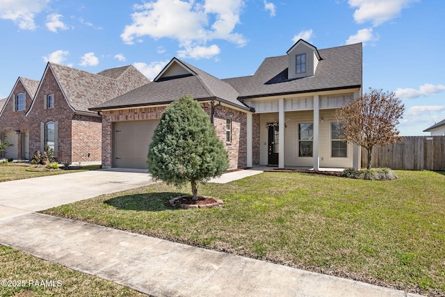 view of front facade featuring a front yard, brick siding, fence, and driveway