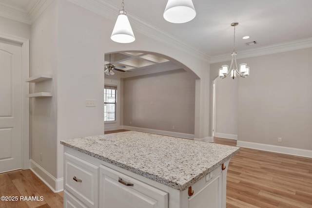 kitchen featuring arched walkways, ceiling fan with notable chandelier, coffered ceiling, white cabinetry, and light wood-style floors