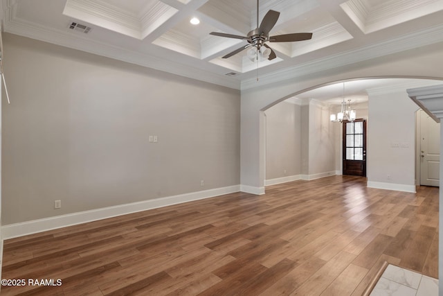 unfurnished room featuring arched walkways, visible vents, wood finished floors, baseboards, and ceiling fan with notable chandelier