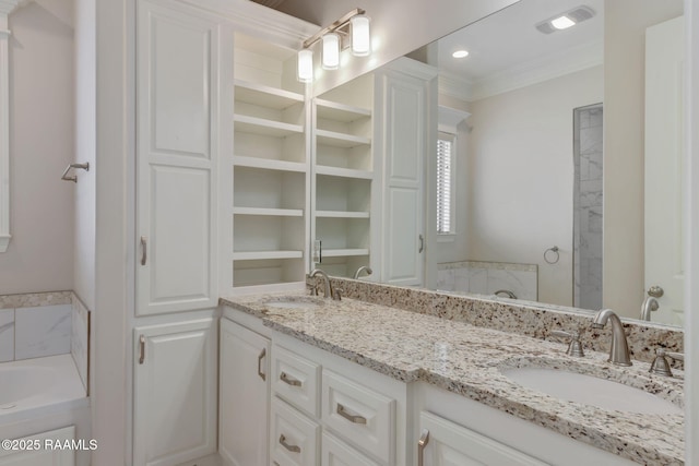 full bathroom with double vanity, a garden tub, ornamental molding, and a sink