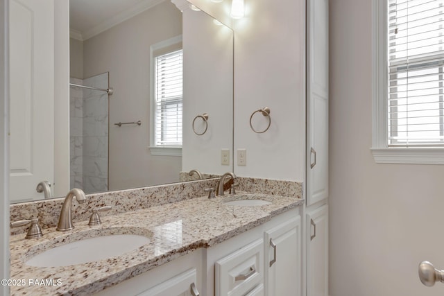 full bath with crown molding, walk in shower, a sink, and double vanity