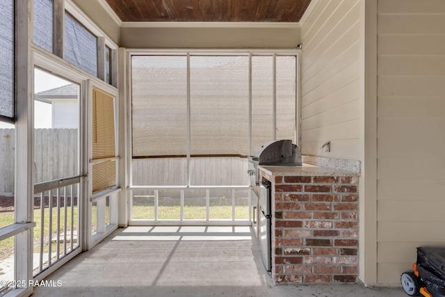 unfurnished sunroom featuring wood ceiling