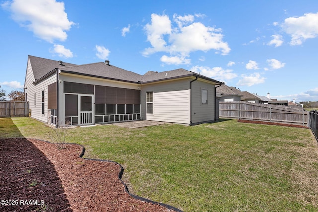 back of house with a lawn, a fenced backyard, and a sunroom