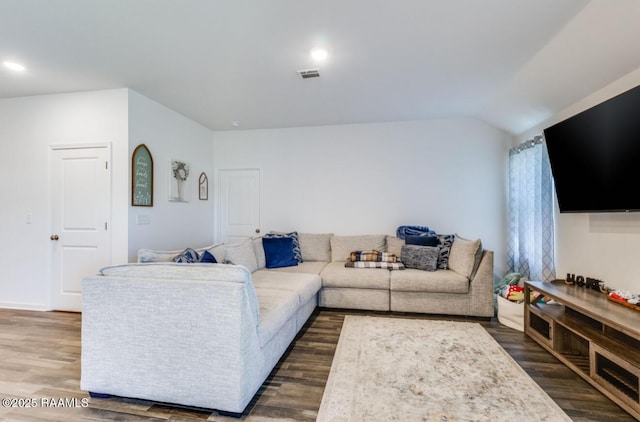 living area featuring lofted ceiling, dark wood-style flooring, visible vents, and recessed lighting