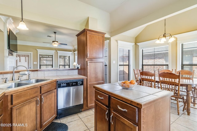 kitchen featuring brown cabinetry, a sink, tile countertops, and stainless steel dishwasher