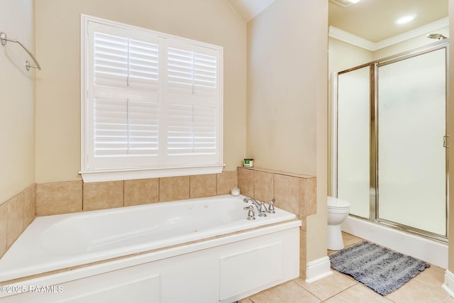 bathroom with a garden tub, a shower stall, toilet, and tile patterned floors