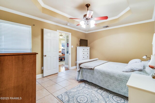 bedroom featuring a raised ceiling, visible vents, crown molding, and light tile patterned floors