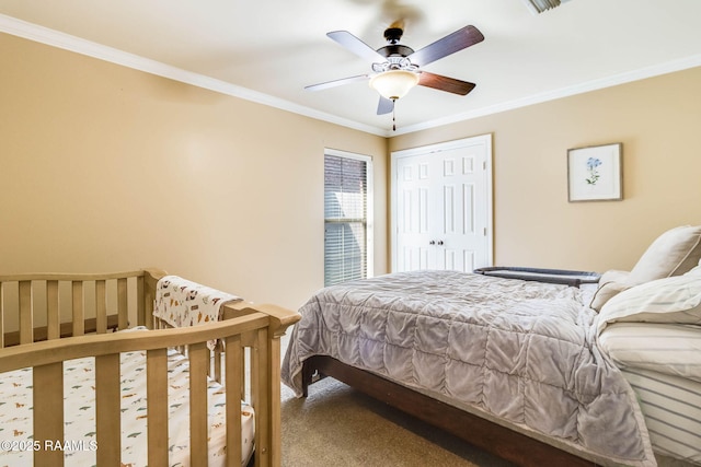 bedroom with carpet, a closet, ceiling fan, and crown molding