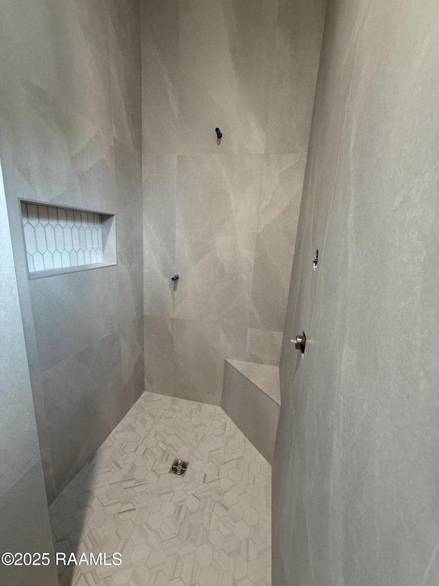 full bath with a tile shower