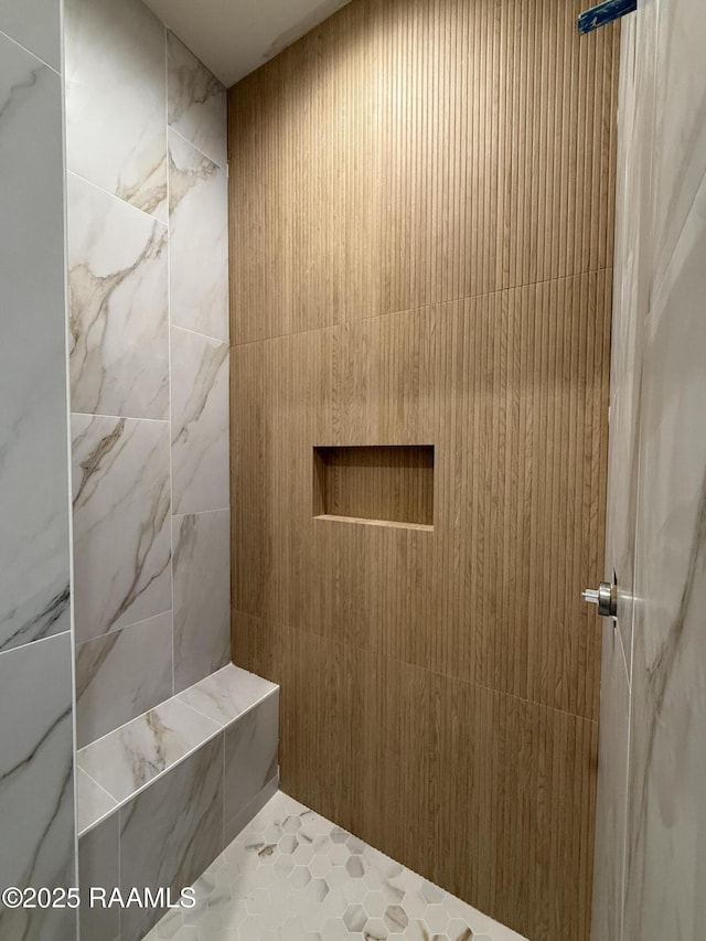 full bathroom with a tile shower